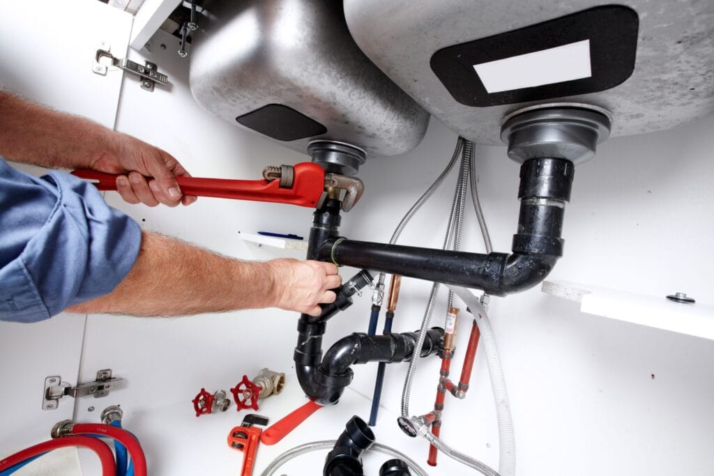 Monterey Plumbing Pros fixing under sink plumbing and drain pipes