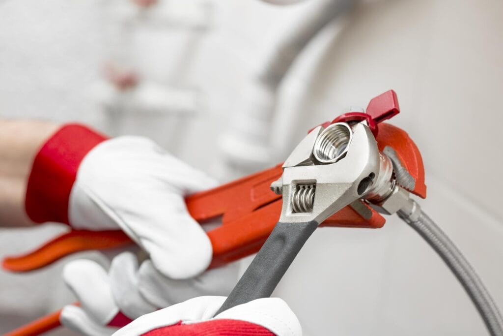 Plumber holding pipe wrenches for an emergency repair in Monterey